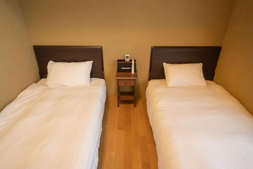 Postel nebo postele na pokoji v ubytování 京都松澗Matsutani