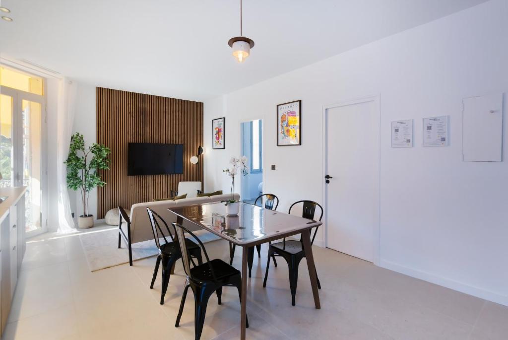 une salle à manger et un salon avec une table et des chaises dans l'établissement Magnifique 3 pièces - Cannes, à Cannes