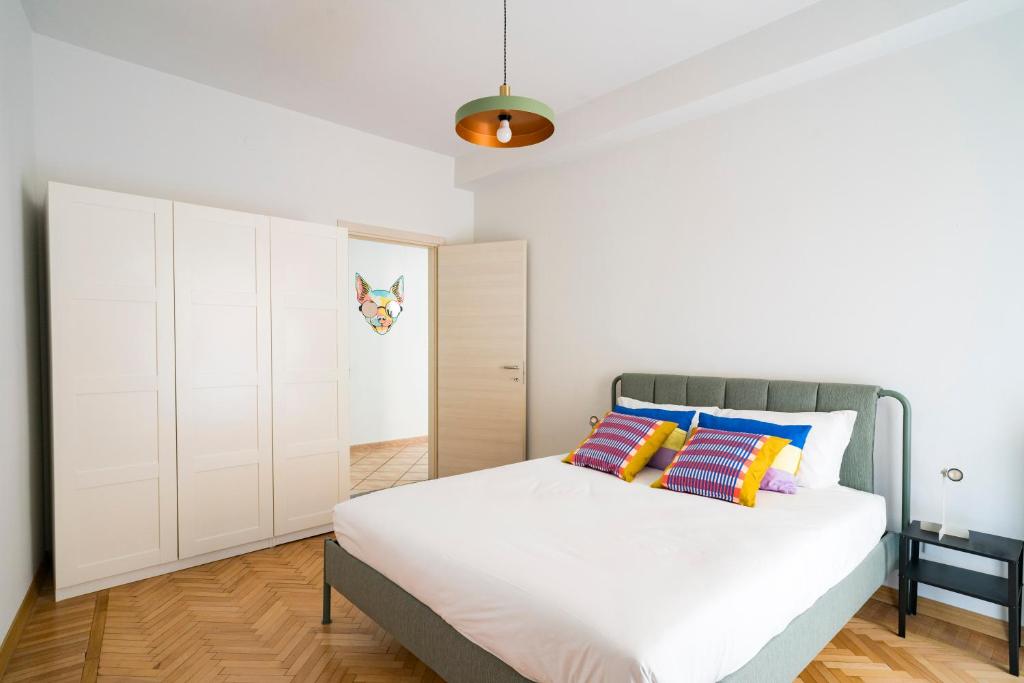 a bedroom with a large bed with white cabinets at Aosta Holiday Apartments - Promis in Aosta
