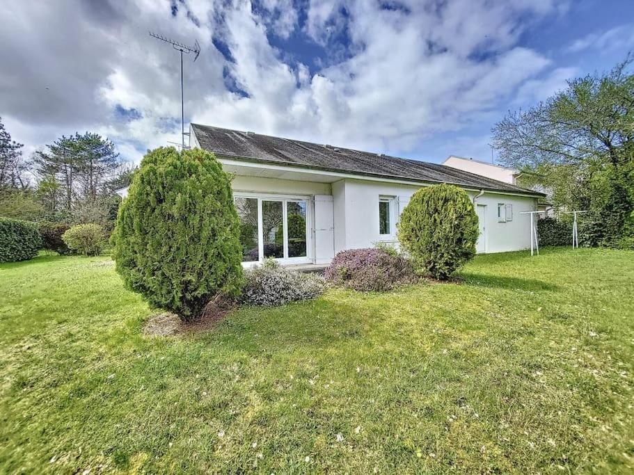 a white house with two trees in the yard at Maison au calme 3 chambres avec terrasse et jardin in Ouzouer-sur-Loire
