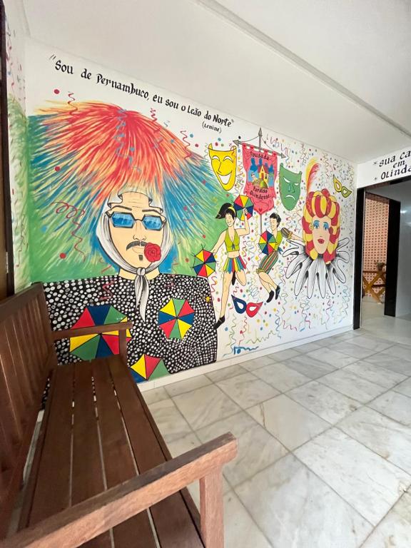 a mural on the wall of a room with a bench at Paraíso Olindense in Olinda
