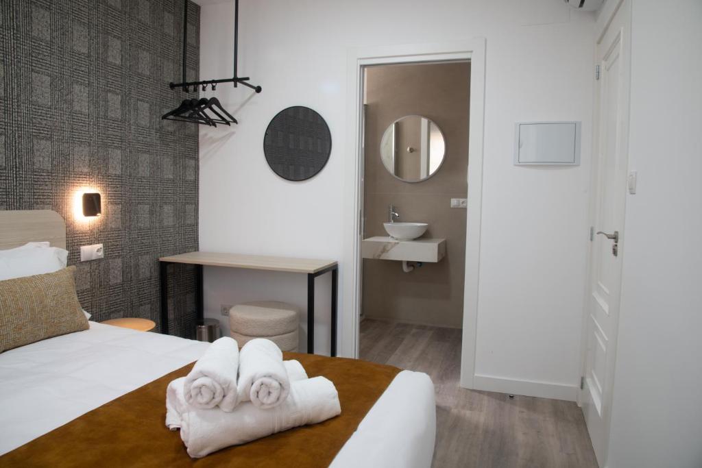 a hotel room with a bed and a sink at Vivienda Fermina Padron in Padrón