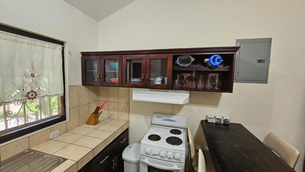 a small kitchen with a stove and a window at Sweet Dreams #4 in Coco