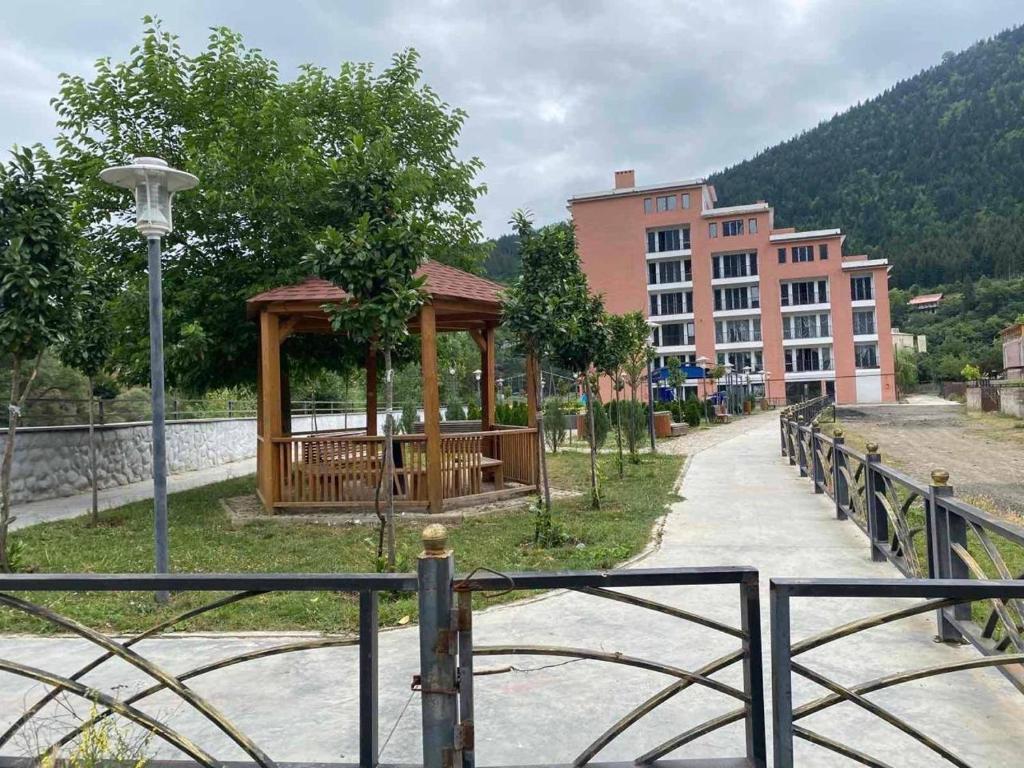 a park with a gazebo next to a building at Svani in Borjomi