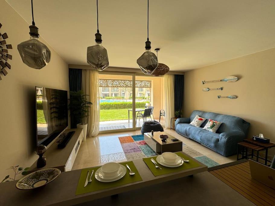 a living room with a blue couch and a table at Luxurious private Getaway in Mangroovy in Hurghada