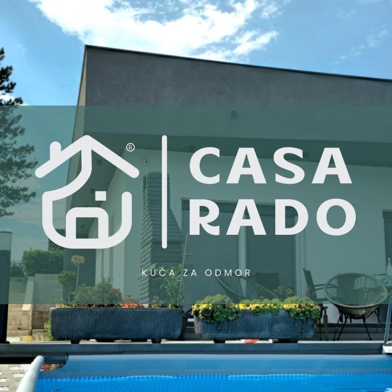 a sign on the side of a building with plants at Casa Rado in Banja Luka