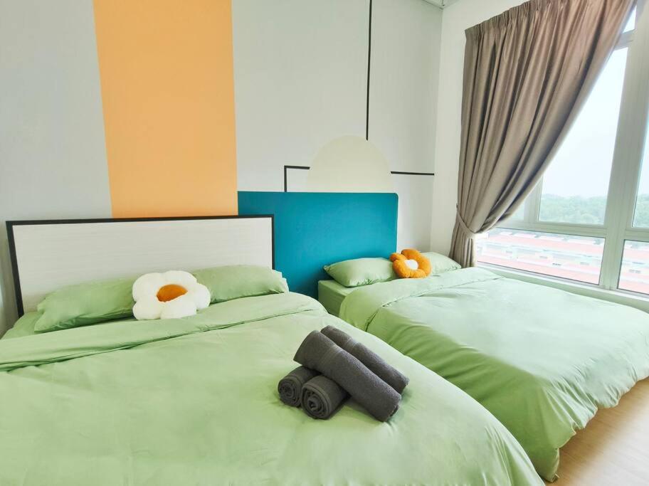 a bedroom with two beds with stuffed animals on them at LV8 MintyMeadow 1-5pax Kuantan in Kuantan