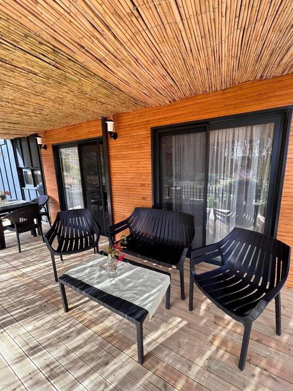 a patio with chairs and a table and a ceiling at Söğüt HOUSES in Marmaris