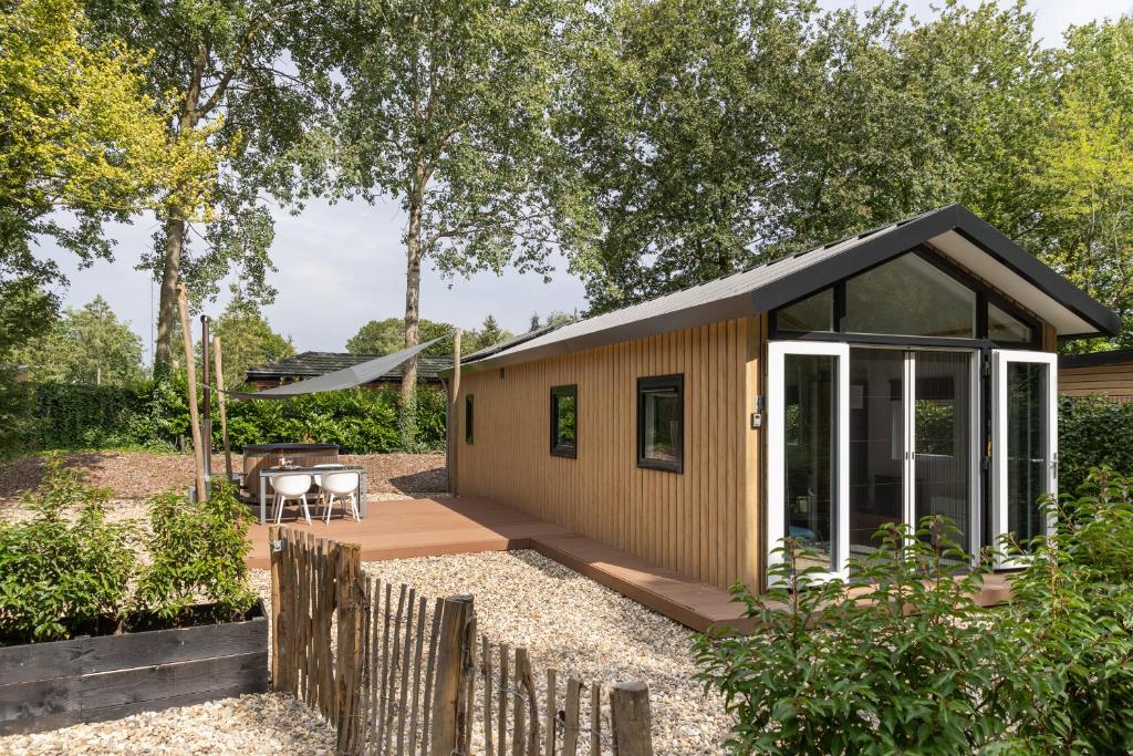 a tiny house with a pitched roof at Schitterend 4 persoons Tinyhouse met HOTTUB aan de bossen in Putten 4-16 in Putten