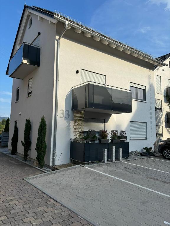 a white building with balconies on the side of it at Ferienwohnung Gergert Nr 5 in Löwenstein
