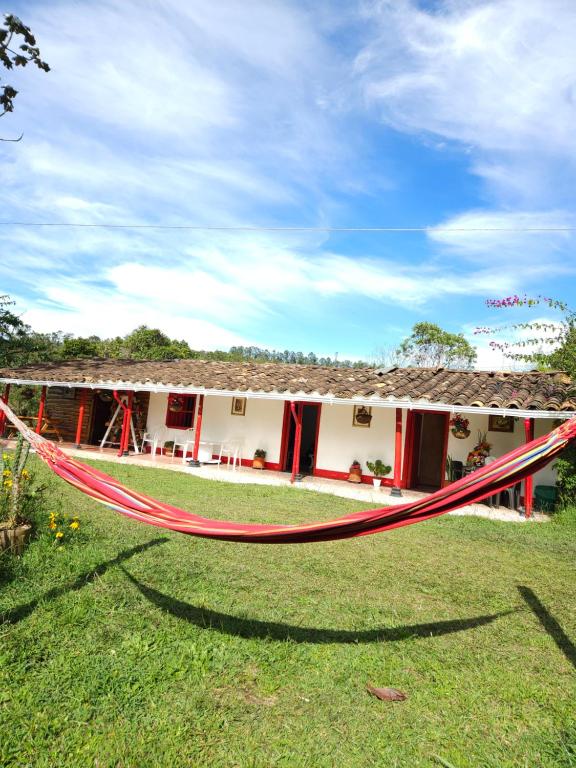 a hammock in front of a house at Casa De Campo "Las Chispas" in Medellín