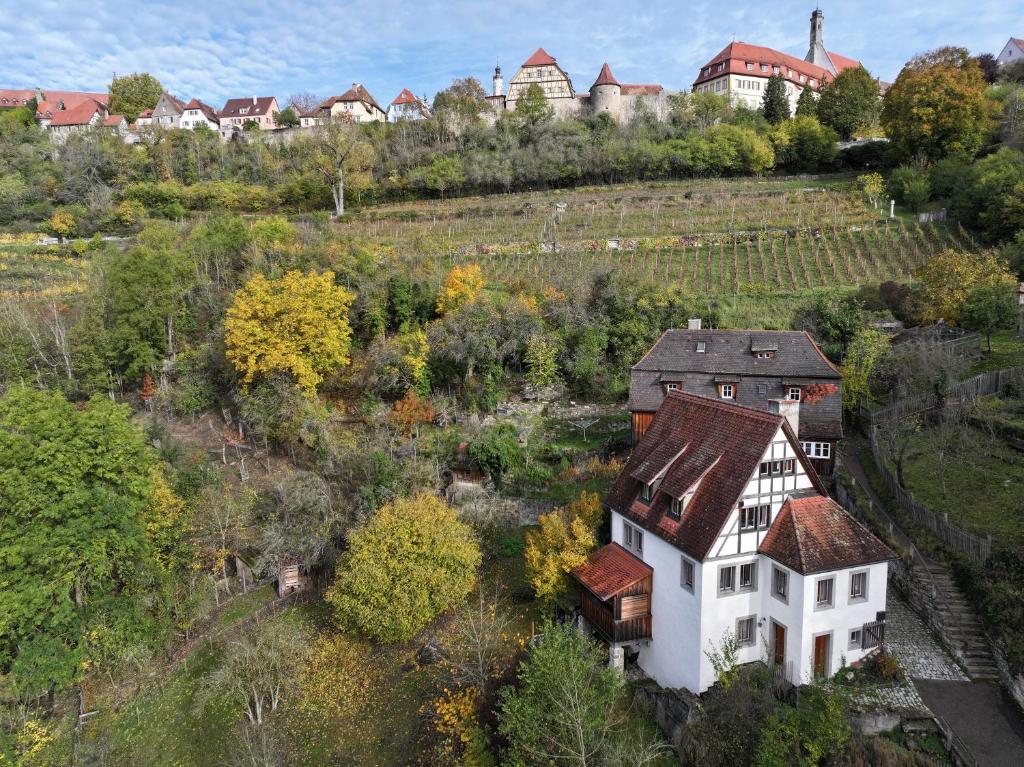 an aerial view of a white house in a field at Ferienhaus Kobolzeller Schlößchen a.d.Weinsteige in Rothenburg ob der Tauber
