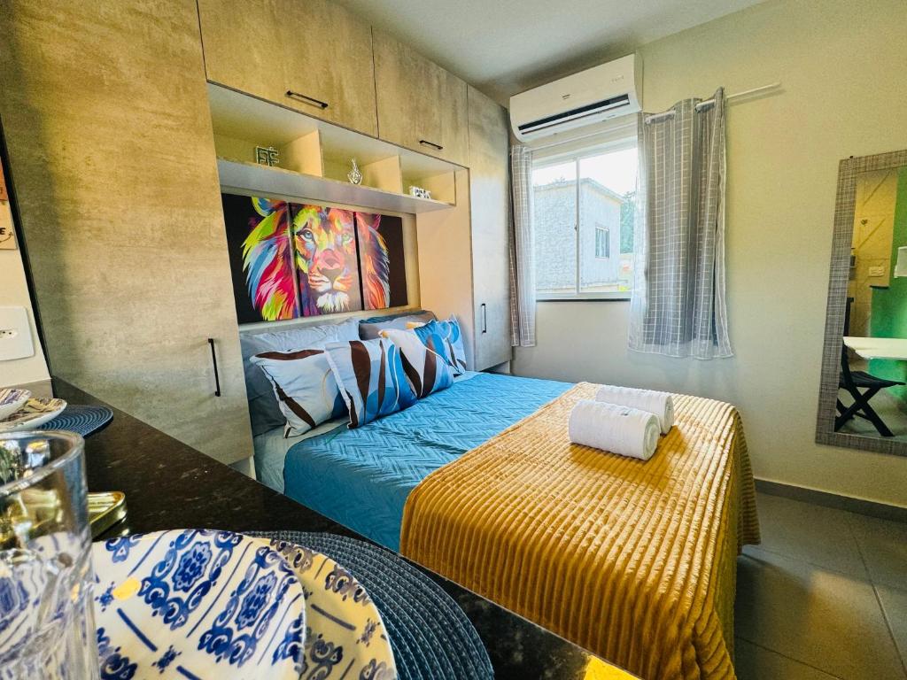 a bedroom with a bed and a table at Stúdio equipado em Xerém - St 6 in Xerém