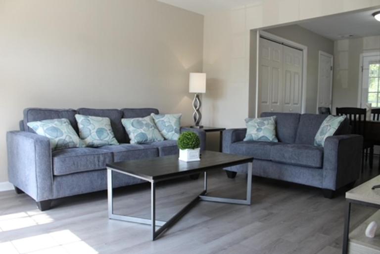 a living room with a couch and a table at Charming 3-bedroom house Scenic&Close to Downtown in Nashville