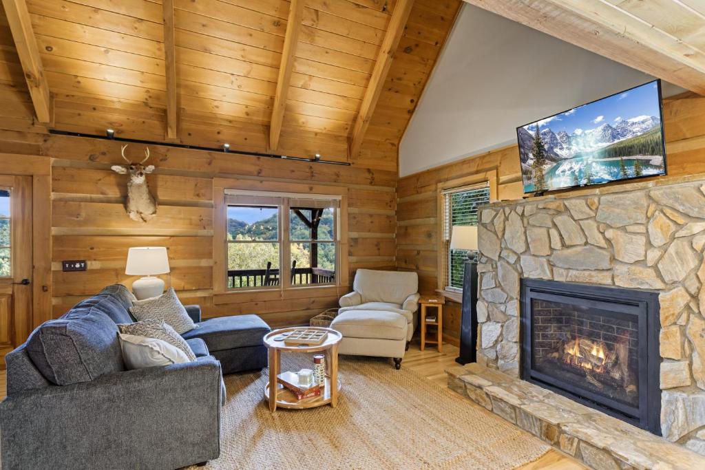 a living room with a fireplace and a tv at Ridgeview in Blowing Rock