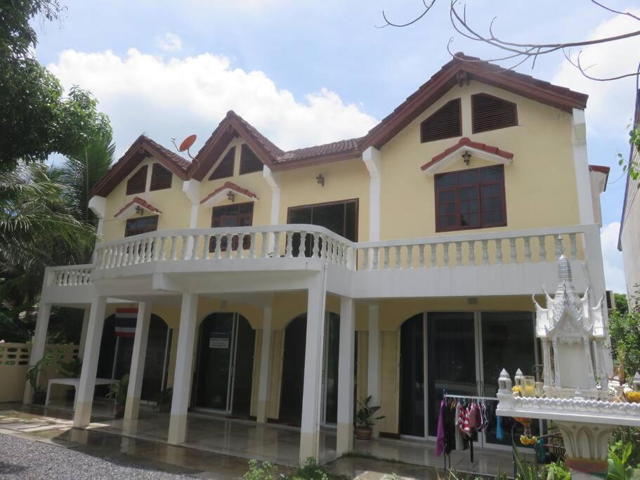 a large white house with a balcony at Private well priced Guesthouse available to rent in Koh Phangan