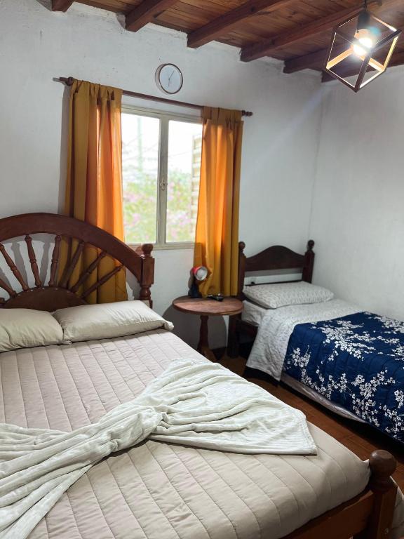 a bedroom with two beds and a window at Los Cactus Planta Alta in La Rioja