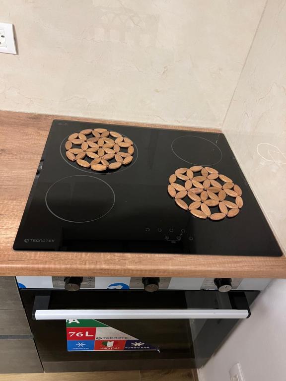 two cookies are sitting on top of a stove at Hilltop Suites in (( Fier-Çifçi ))