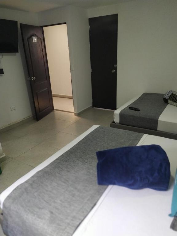Postel nebo postele na pokoji v ubytování Hotel Palo Alto Laureles