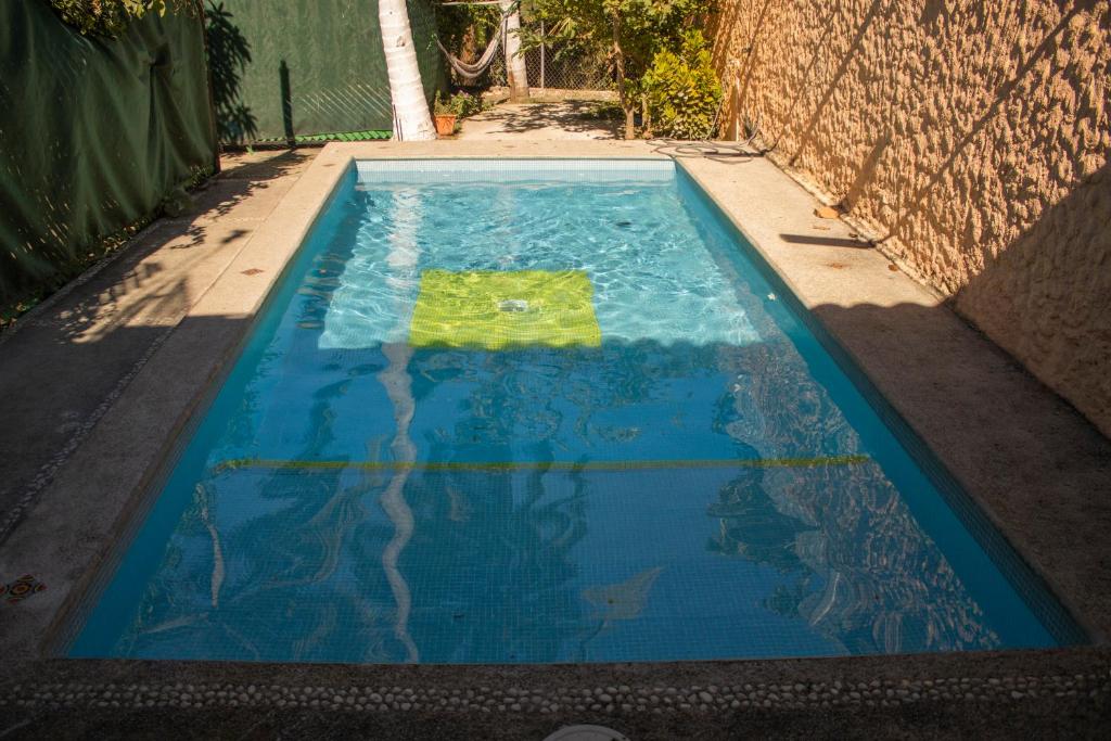 a pool of water in a street next to a building at C1 Casa cerca de Guayabitos con alberca privada, 10 huéspedes in Peñita de Jaltemba