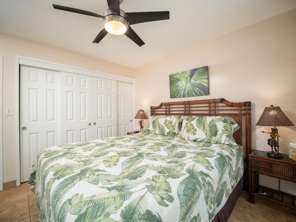 a bedroom with a bed and a ceiling fan at WBH D116 Aloha Wai - Garden Suite Just Steps from the Sea in Kihei