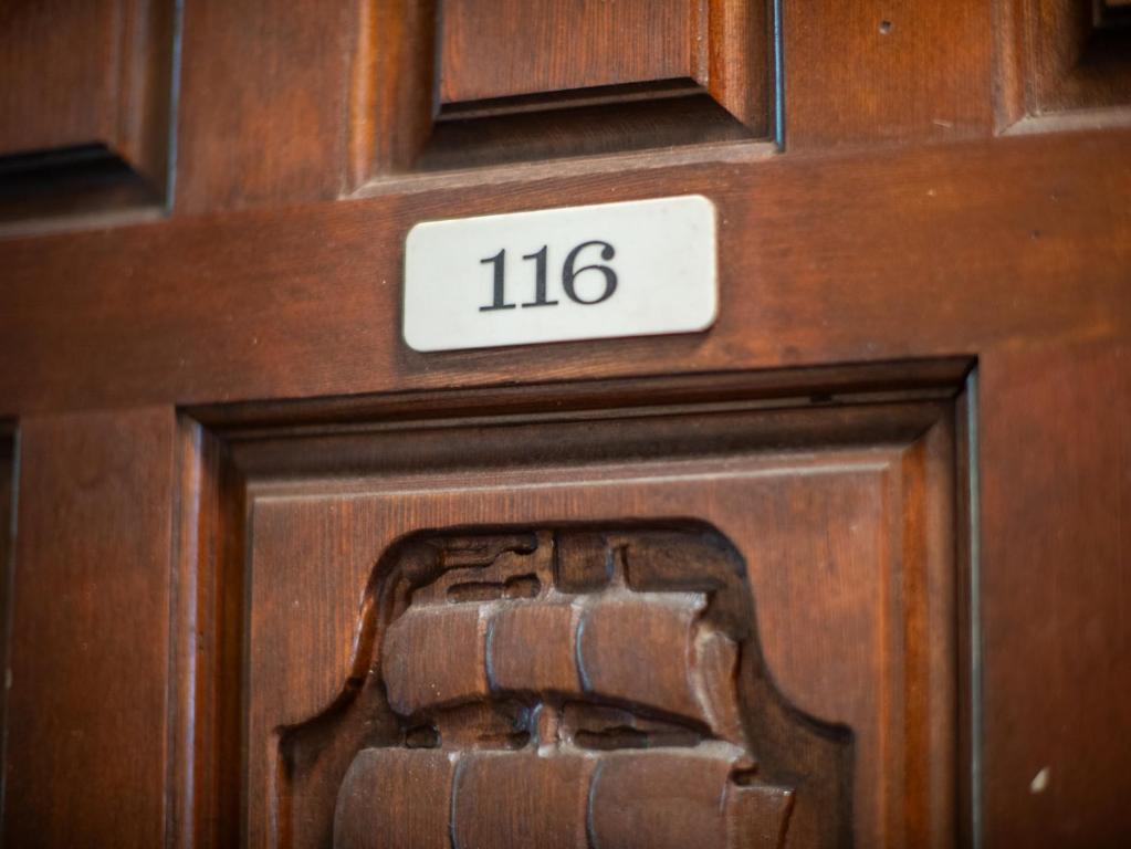 a wooden door with the number on it at WBH D116 Aloha Wai - Garden Suite Just Steps from the Sea in Kihei