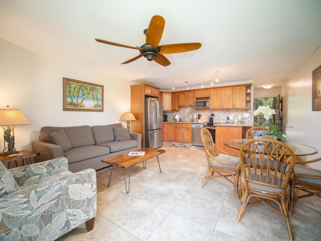 a living room with a couch and a table at WBH D116 Aloha Wai - Garden Suite Just Steps from the Sea in Kihei