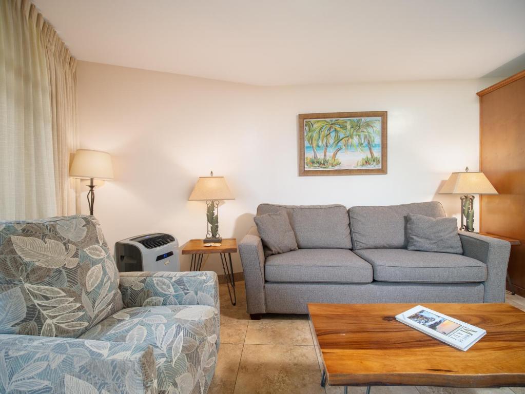 a living room with a couch and a table at WBH D116 Aloha Wai - Garden Suite Just Steps from the Sea in Kihei