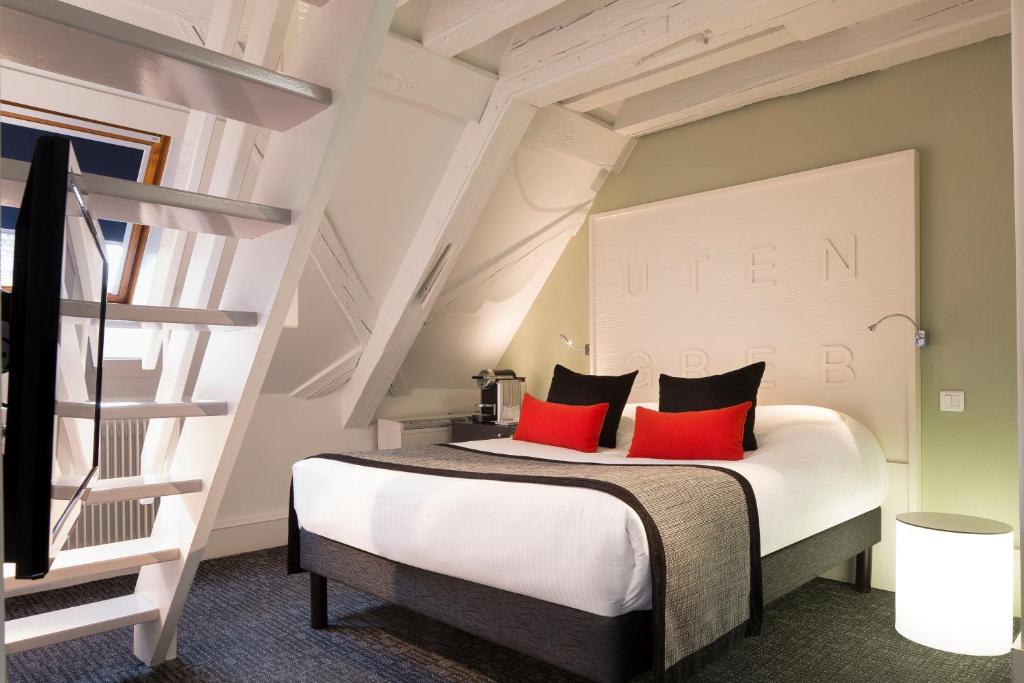 Postel nebo postele na pokoji v ubytování Hôtel Gutenberg