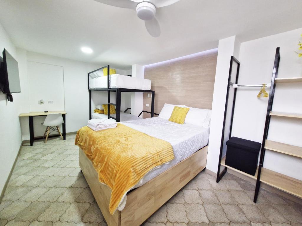 a bedroom with a large bed and a desk at Confortable Apartamento Familiar Apto 5 in Guatemala