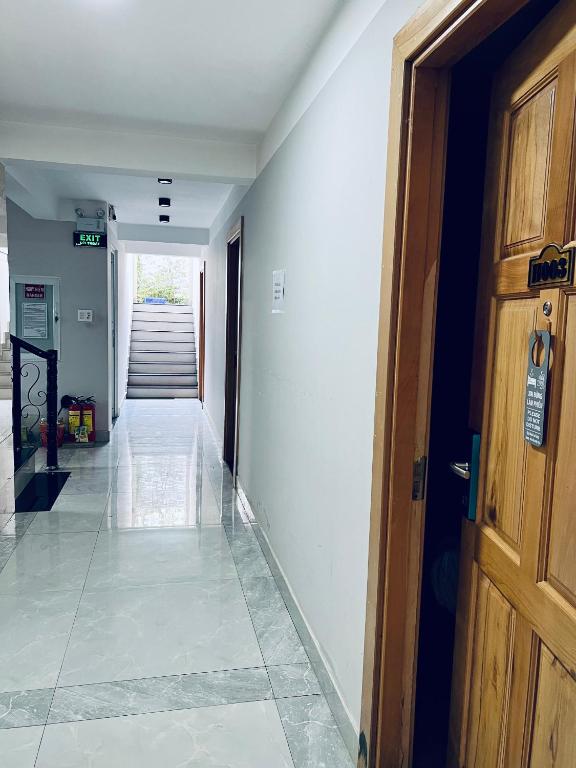 an empty hallway with a door and a staircase at Dalat Wind Hotel in Da Lat