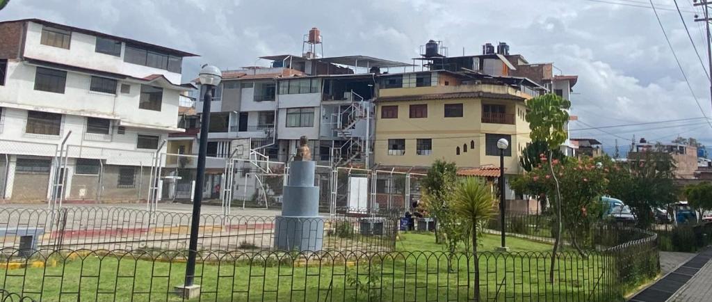 a building with a fence in front of it at Moderno Apto Estudio 02 in Cajamarca