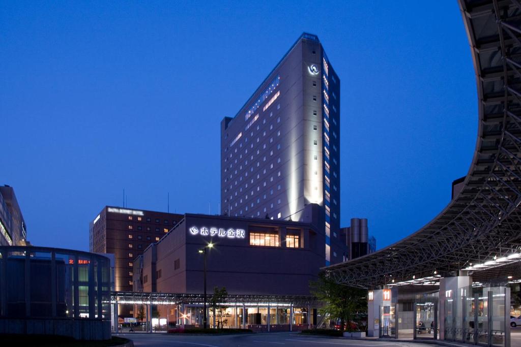 a tall building with a sign on the side of it at Hotel Kanazawa in Kanazawa