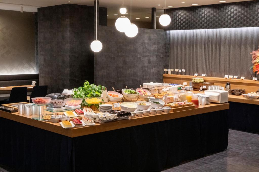 a buffet of food on a table in a restaurant at Hotel Kanazawa in Kanazawa