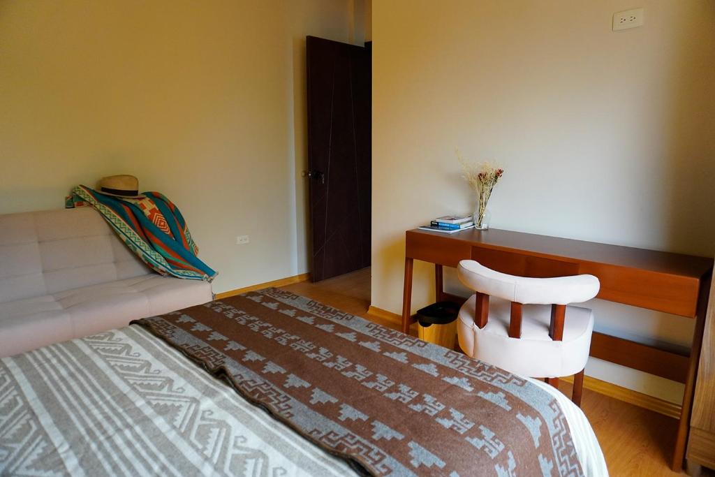 Postel nebo postele na pokoji v ubytování Laguna de Cuicocha Guest House