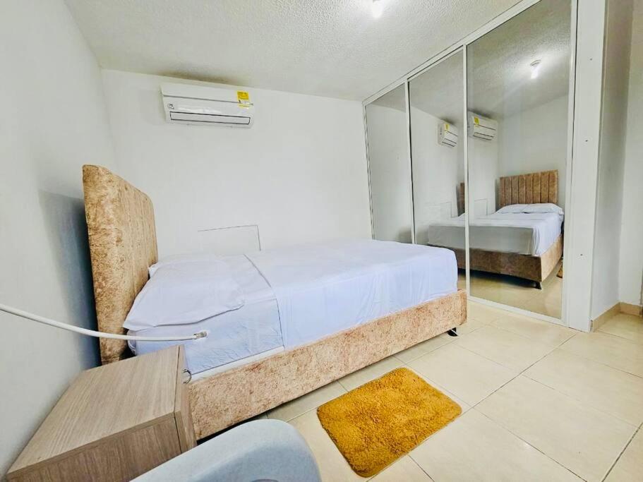 a bedroom with two beds and a mirror at Apartamento Villa San Pedro in San Roque