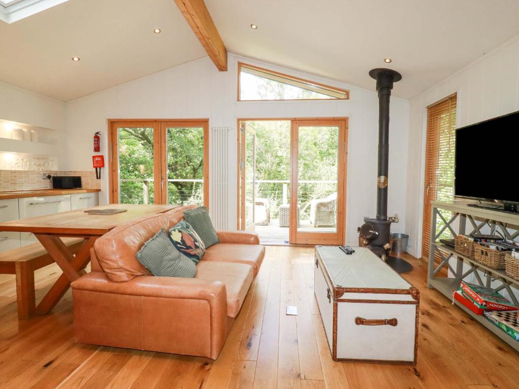 a living room with a couch and a table at 4 Stonerush Valley in Looe