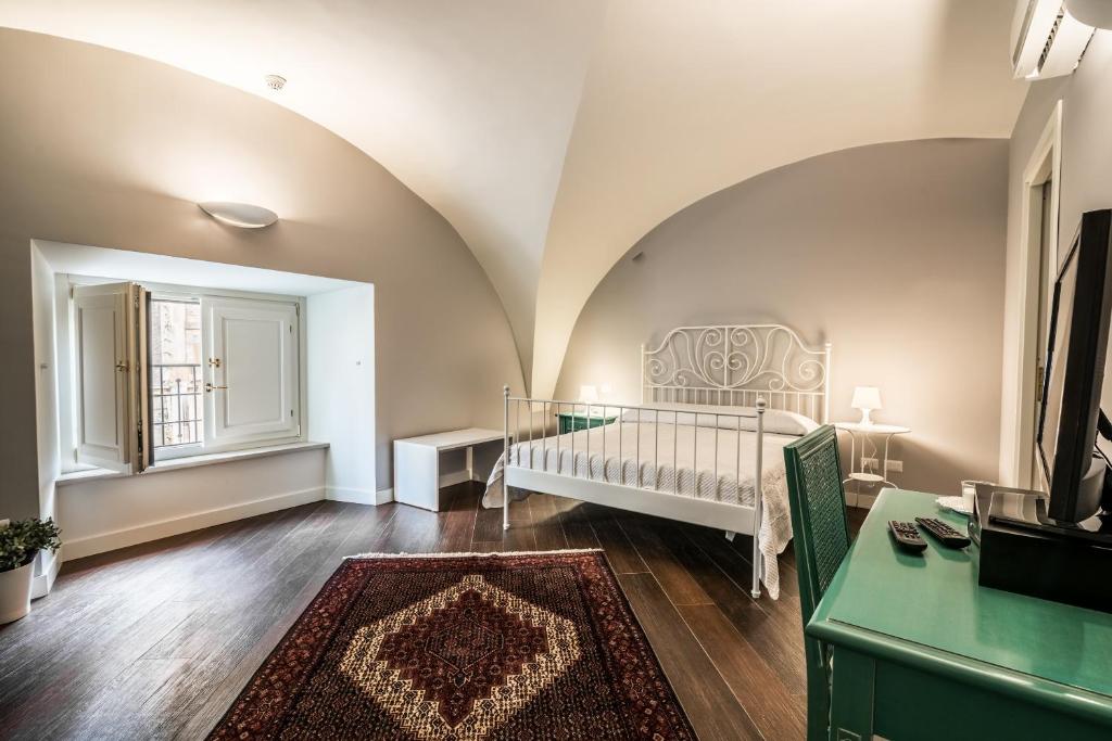 a bedroom with a crib in a room at Residenza Cavour in Acireale
