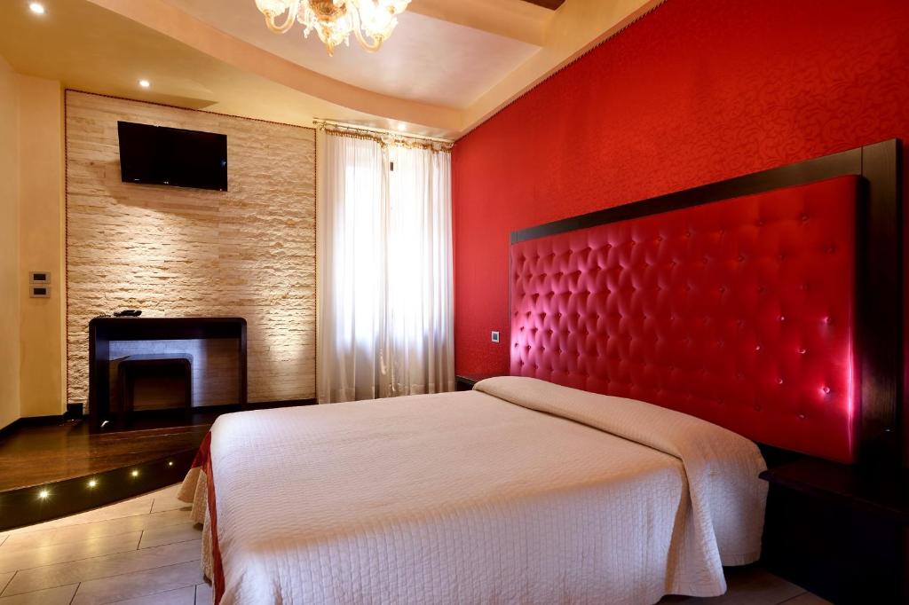 Postel nebo postele na pokoji v ubytování Hotel Abbazia