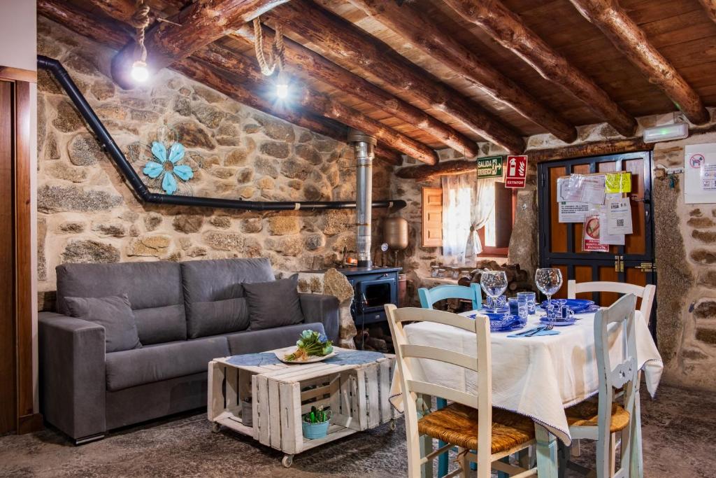 a living room with a table and a couch at La Cuadra in Villar de Corneja