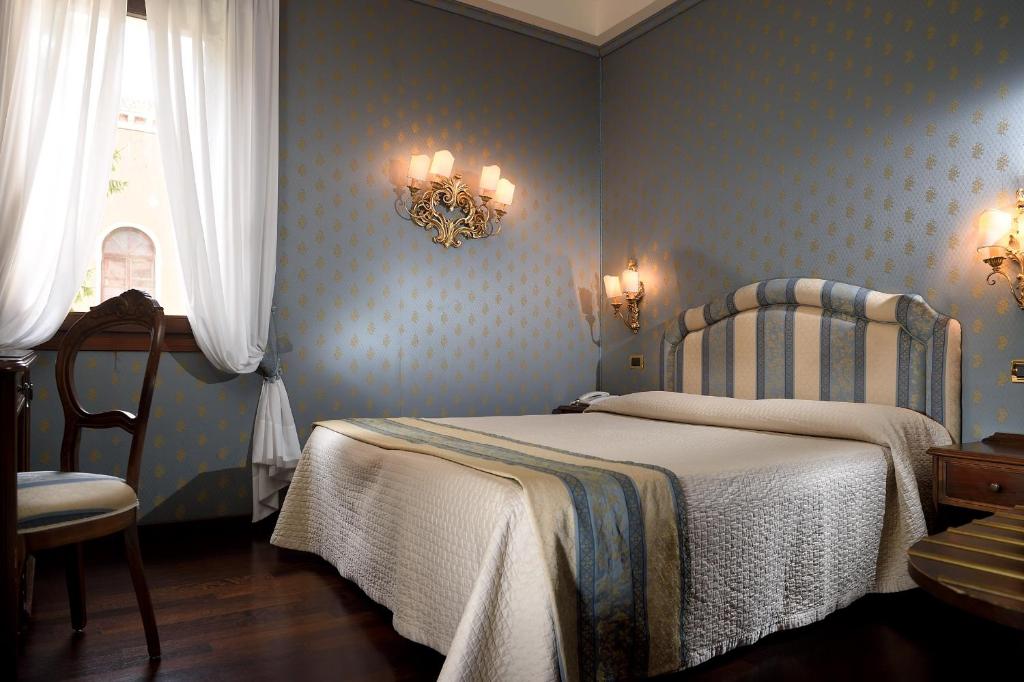 Postel nebo postele na pokoji v ubytování Hotel Abbazia
