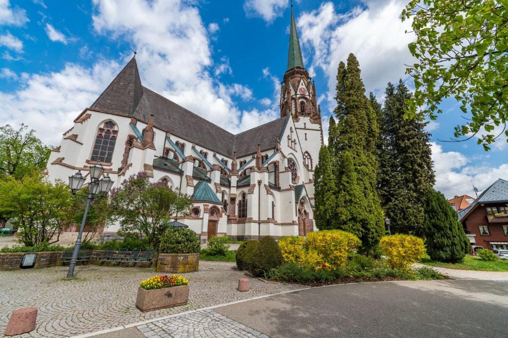 a large white church with a steeple on top of it at Haus Am Bühl in Schönau im Schwarzwald