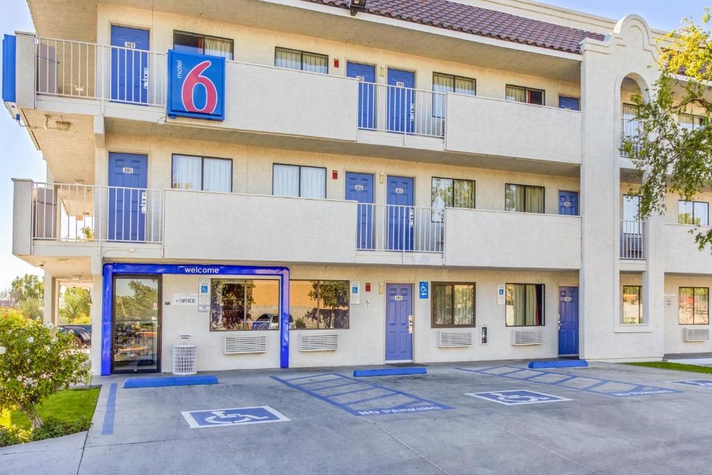 a hotel with blue doors in front of a building at Motel 6-Phoenix, AZ - West in Phoenix