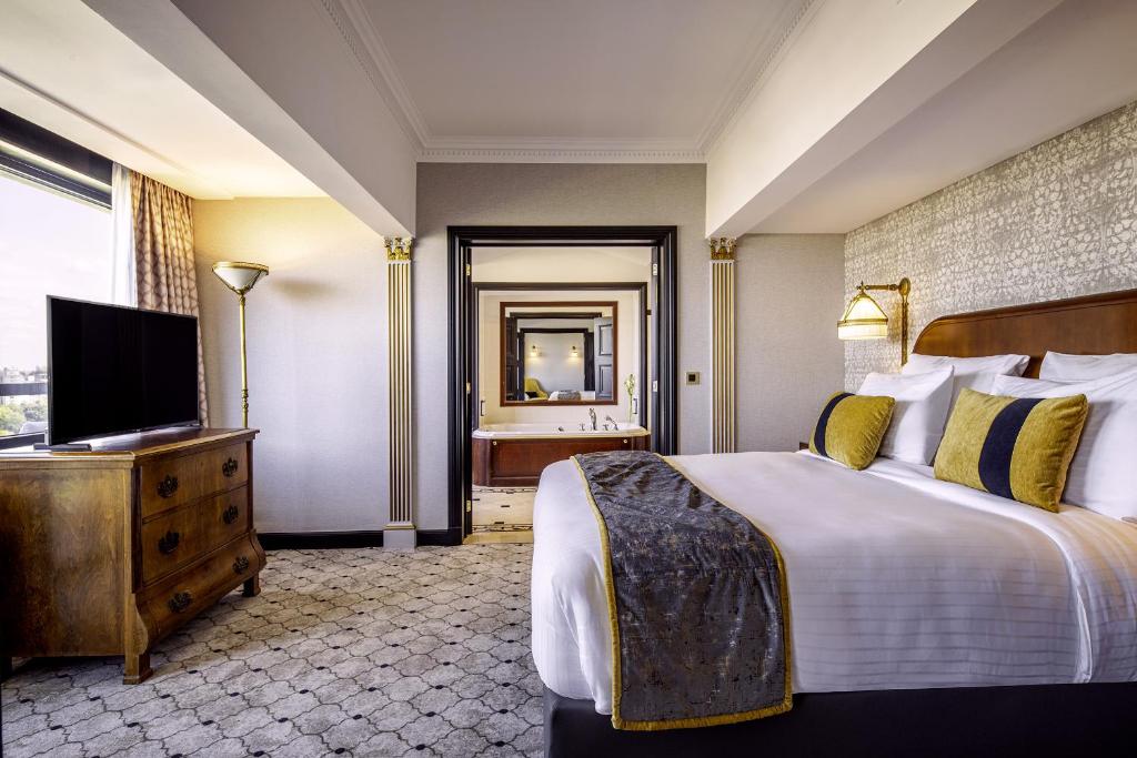 a hotel room with a bed and a television at Hotel Barsey by Warwick in Brussels