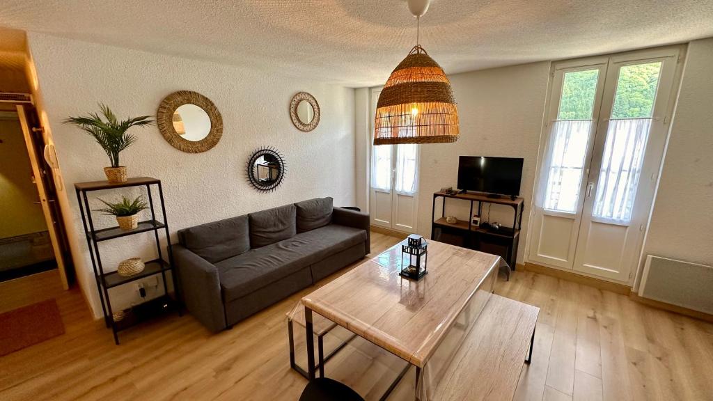 un salon avec un canapé et une table dans l'établissement LBonheur au Sancy 4 à 6 pers, à Le Mont-Dore