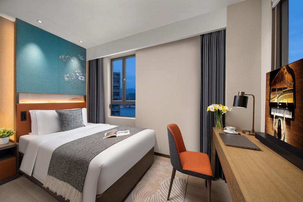 Łóżko lub łóżka w pokoju w obiekcie Ascott North Point Hong Kong