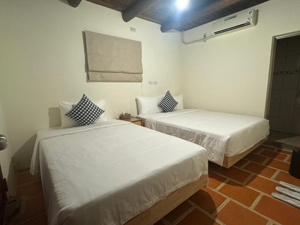 Postel nebo postele na pokoji v ubytování Minnan Homestay