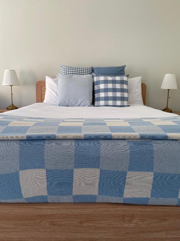 a blue and white bed with pillows on it at Euroa Motor Inn in Euroa