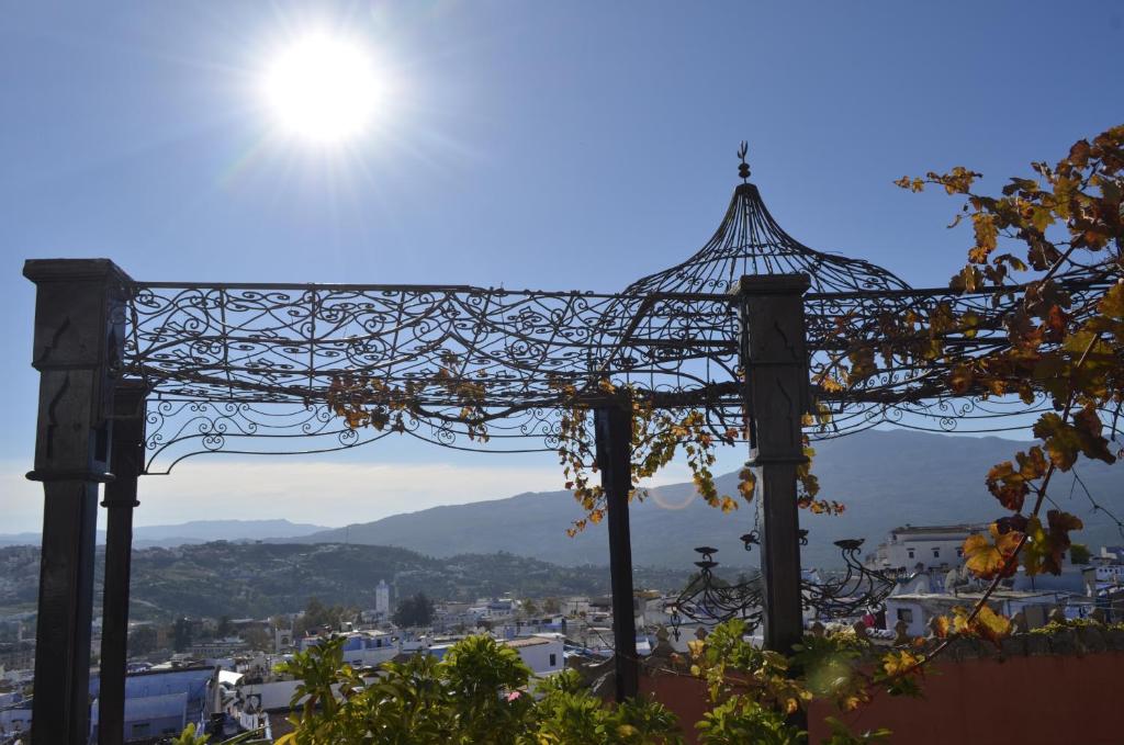 a view of the sun through a metal structure at Dar Meziana in Chefchaouen