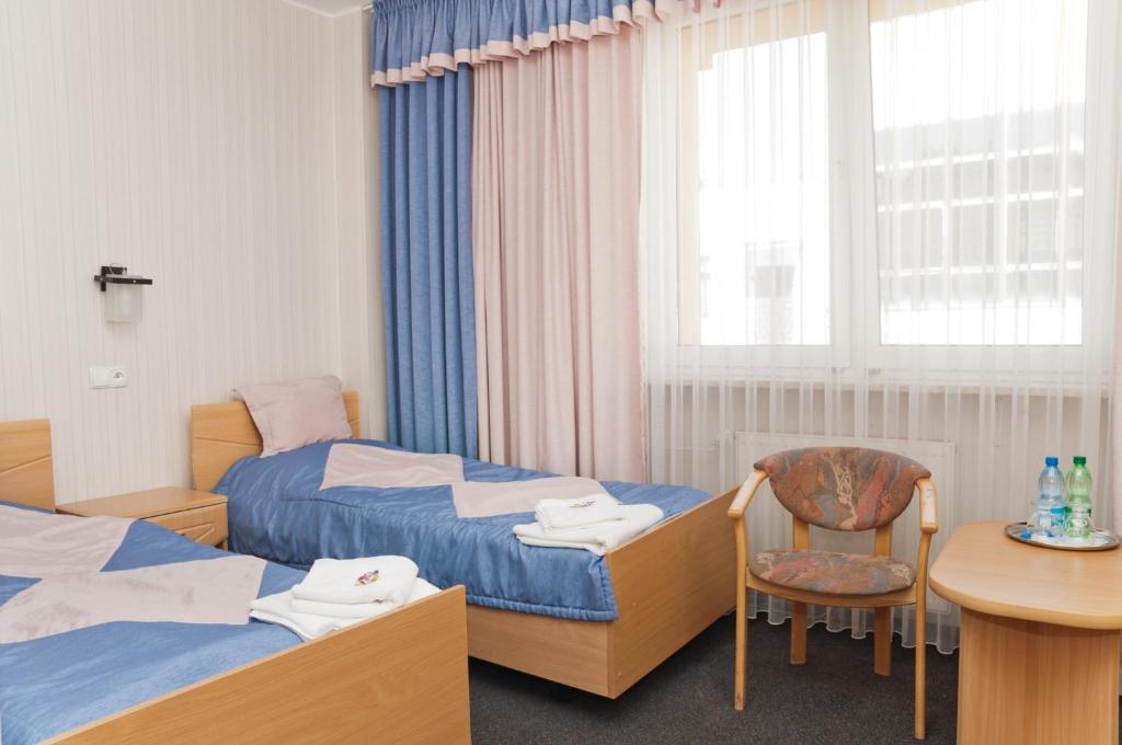 Łóżko lub łóżka w pokoju w obiekcie Vistula Hotel